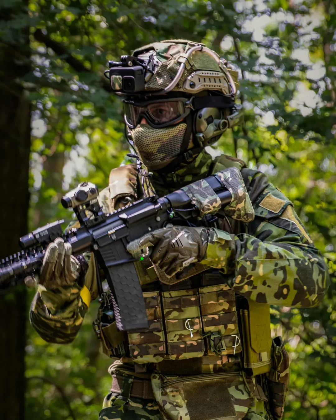 Nikola “Niko” Atanasov of GFA Airsoft in helmet, goggles and full kit, aiming his airsoft rifle in a forest